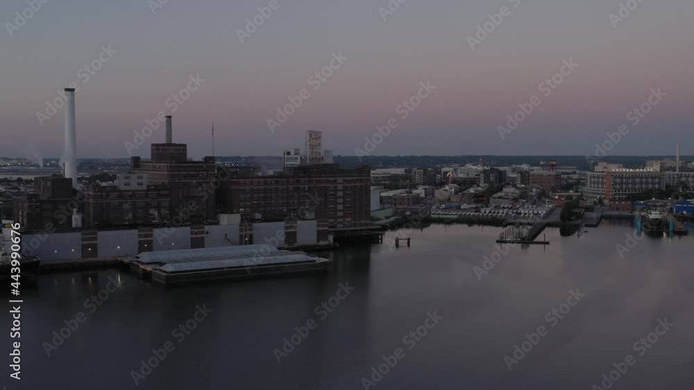 Aerial pan from factory to a marina along the Patapsco river in Baltimore Maryland at blue hour sunrise Aerial pan from factory to a marina along the Patapsco river in Baltimore Maryland at blue hour sunrise