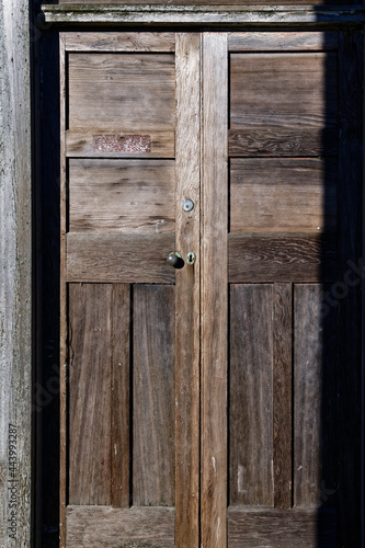 An old wooden door glows in the sun.