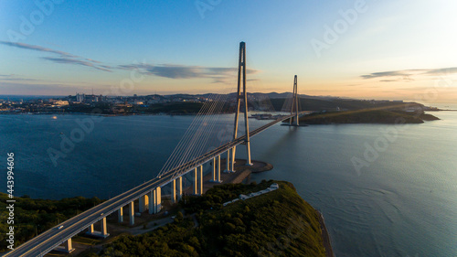 Russian bridge across the Eastern Bosphorus Strait in Vladivostok. View from above. Russian bridge against the background of a beautiful sunrise.