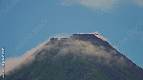 Arenal Volcano active andesitic stratovolcano With the movement of clouds around the summit photo