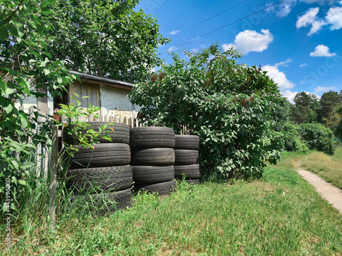 old car tires in the village, in nature.