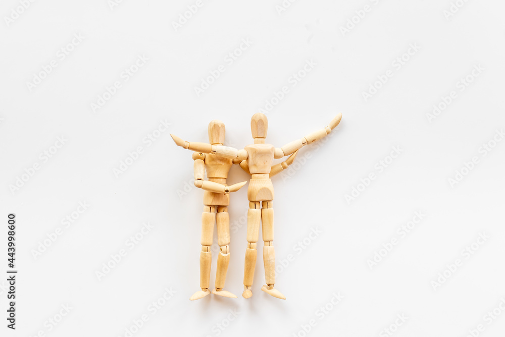 Two wooden figure connection - emotional communication concept Two wooden figure connection - emotional communication concept