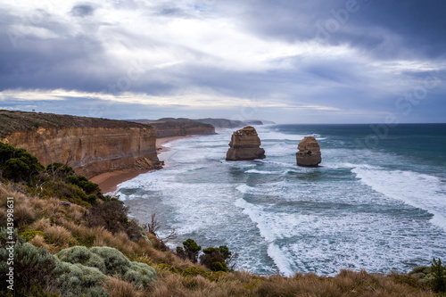 Stormy evening view from the cliff to the ocean wide waves and rocky shores Twelve Apostles Sea Rocks near Great Ocean Road, Port Campbell National Park, Australia.
