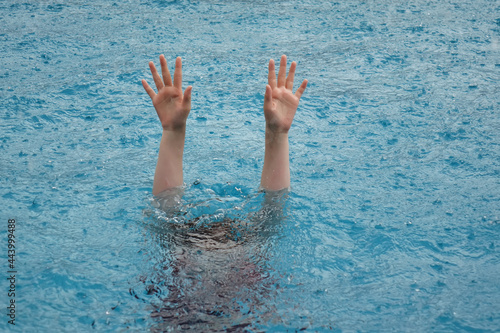 girl's hand drowning in the rain 