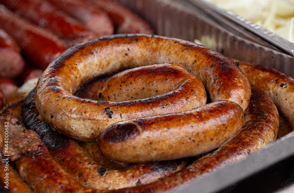 Smoked sausage cooked at an outdoor summer event Smoked sausage cooked at an outdoor summer event