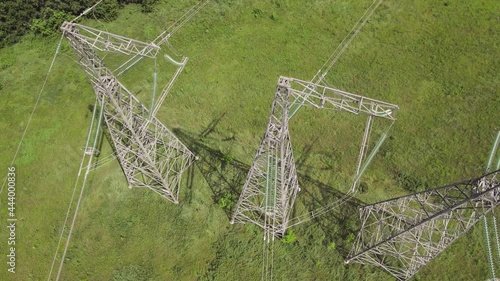 Aerial Top view High voltage power line on industrial electricity line tower. Energy transmisson with overhead power line photo