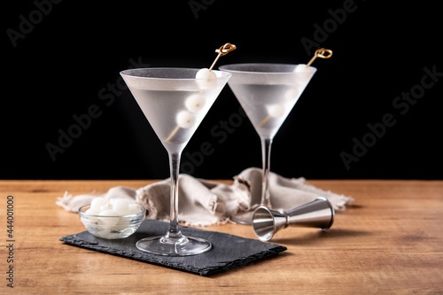 Gibson martini cocktail with onions on wooden table photo