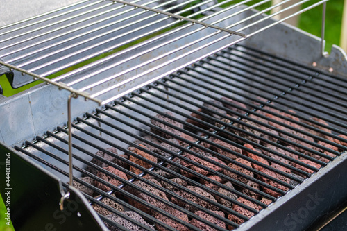 Fragment of a gas barbecue grill with lava stones. Selective focus.