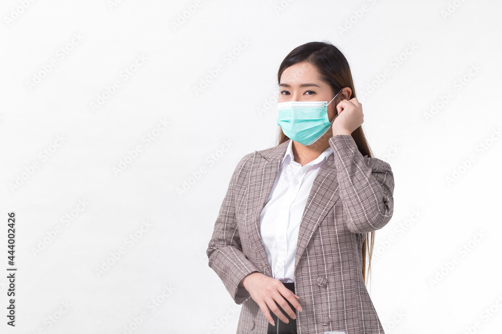 Asian business female wears formal suit and medical face mask to protect infection disease (COVID-19) in healthcare, new normal concept. Asian business female wears formal suit and medical face mask to protect infection disease (COVID-19) in healthcare, new normal concept.