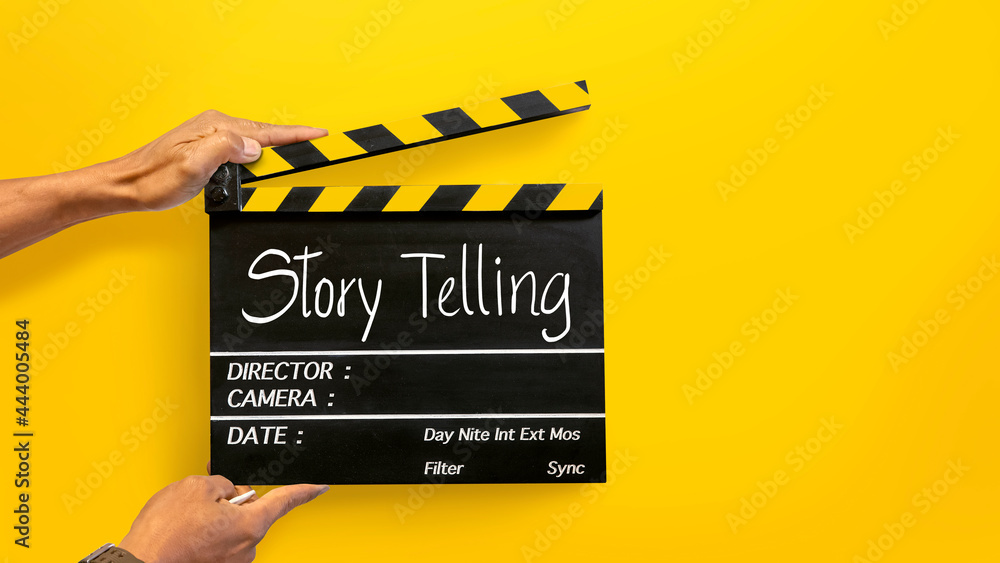 Storytelling concept.Handwriting on film slate.its uses in video production, film, cinema industry, and yellow backgrounds.