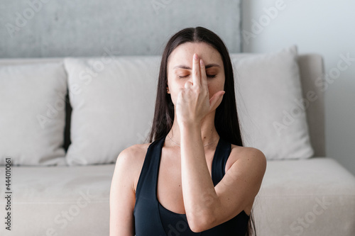 Photography Young woman performing alternate nostril breathing exercise