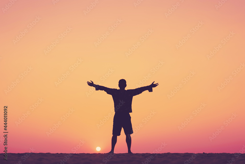 Copy space of man rise hand up on sunset sky at beach and island background.