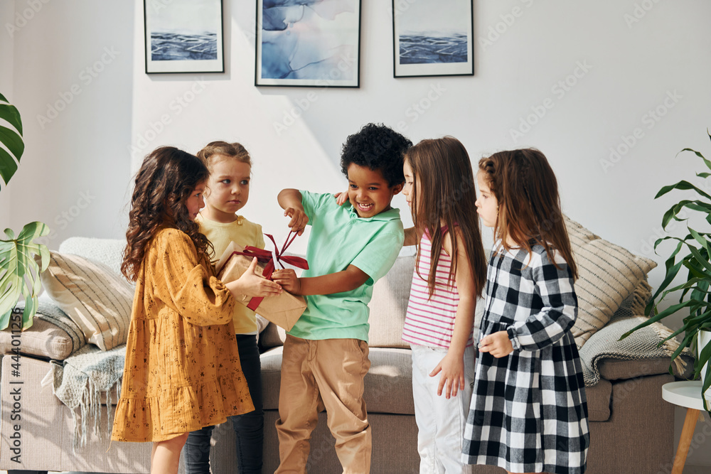 At home. Children on celebrating birthday party indoors have fun together At home. Children on celebrating birthday party indoors have fun together