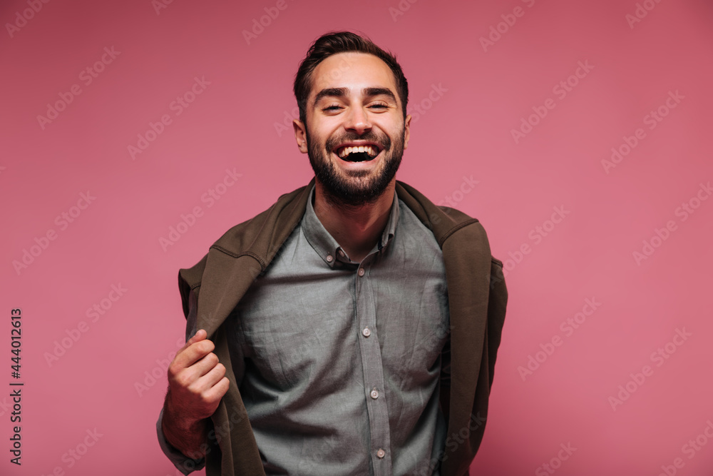 Portrait of happy guy putting off his jacket and laughing Portrait of happy guy putting off his jacket and laughing
