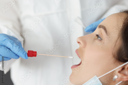 Doctor in front of biological material of saliva from patient for diagnosis of covid