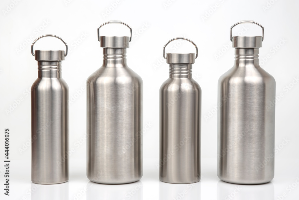 Steel flasks for water and drinks on a white background. Survival hiking gear Steel flasks for water and drinks on a white background. Survival hiking gear