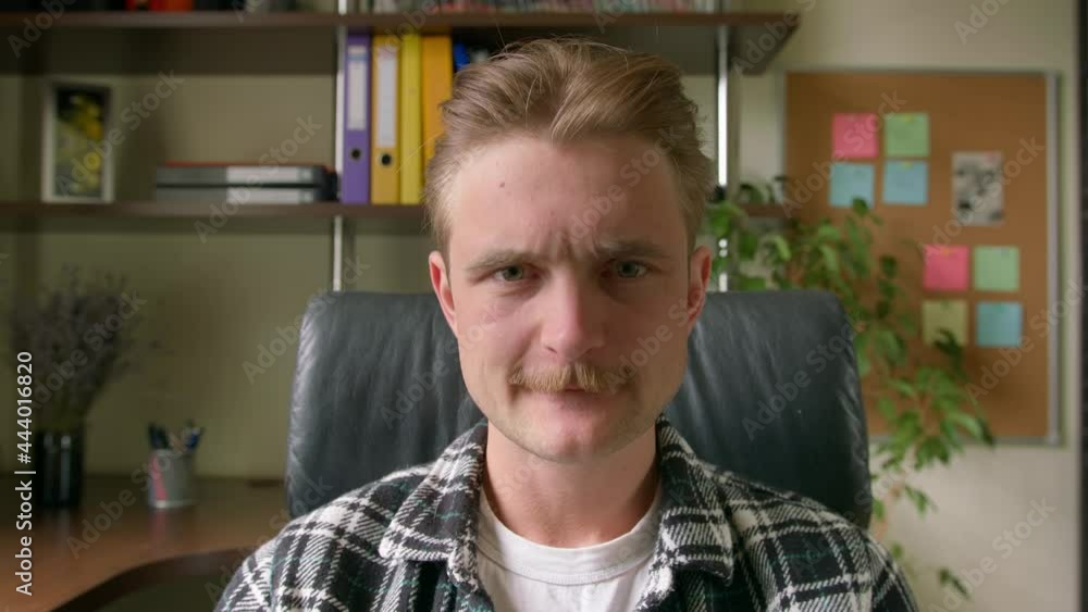 Young man nervously, upset looking at the camera, biting his lips Young man nervously, upset looking at the camera, biting his lips