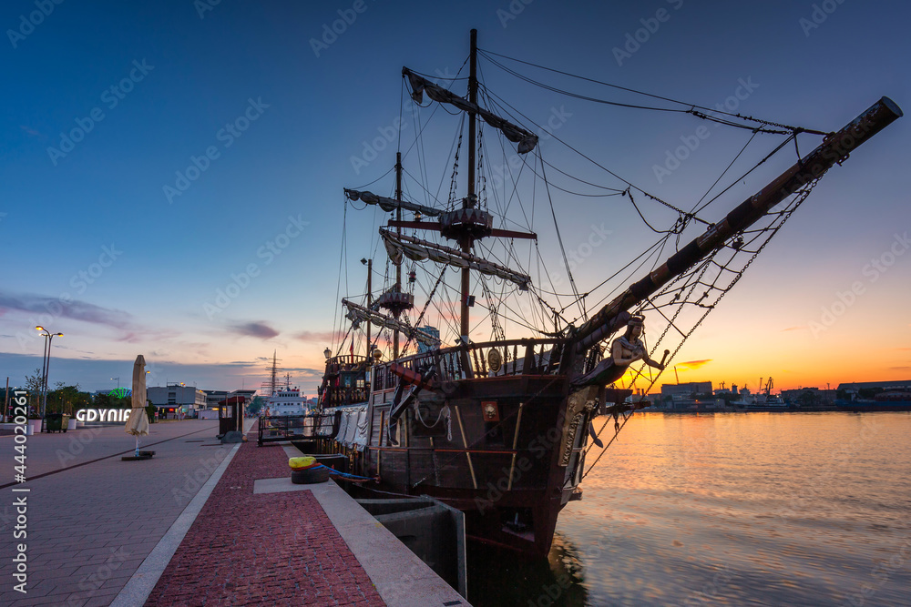 Fototapeta Port w Gdyni ze statkiem pirackim o zachodzie słońca. Polska