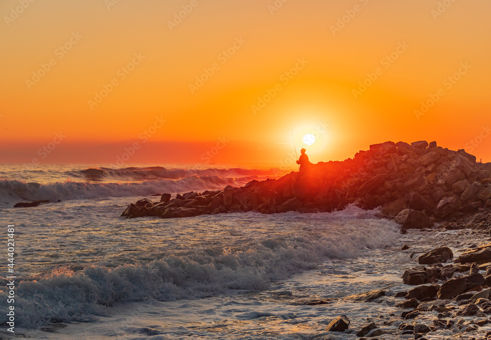 Dark blue waves against the beautiful orange sunset at the Black Sea, Anapa, Russia