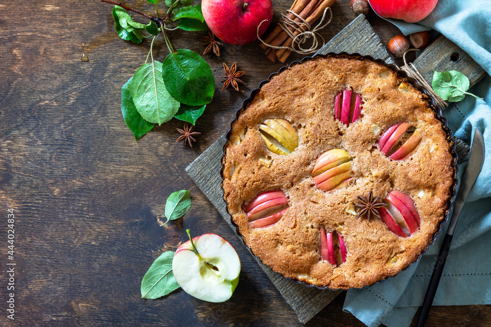 Fototapeta premium Apple baking gluten free seasonal. Autumn pie with apples, hazelnut and cinnamon on a wooden table. Top view flat lay background. Copy space.