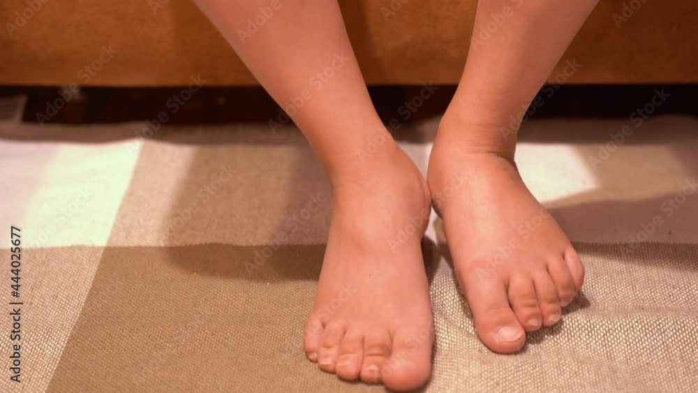 A woman with swelling on her legs massages her legs with a massage
