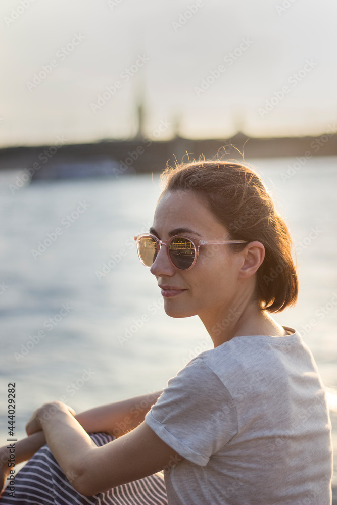 woman with short red hair smiling at sunset. Romantic vintage concept