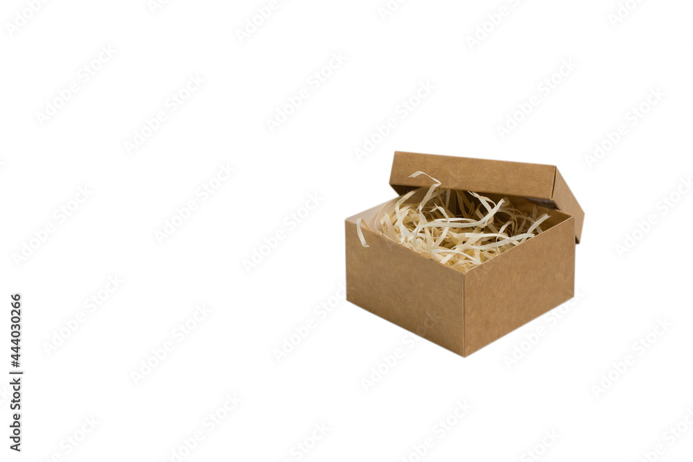 Square craft box with wood filler, isolated on white background. The concept of choosing a gift and preparing for the holiday Square craft box with wood filler, isolated on white background. The concept of choosing a gift and preparing for the holiday