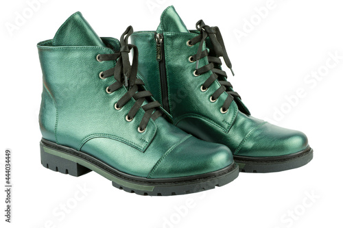 Green leather shoesisolated on white background. Winter and spring off-season boots. Stylish boot. Close-up. Laces, tractor sole. Casual style. Copy space. Pearlescent fashionable color.