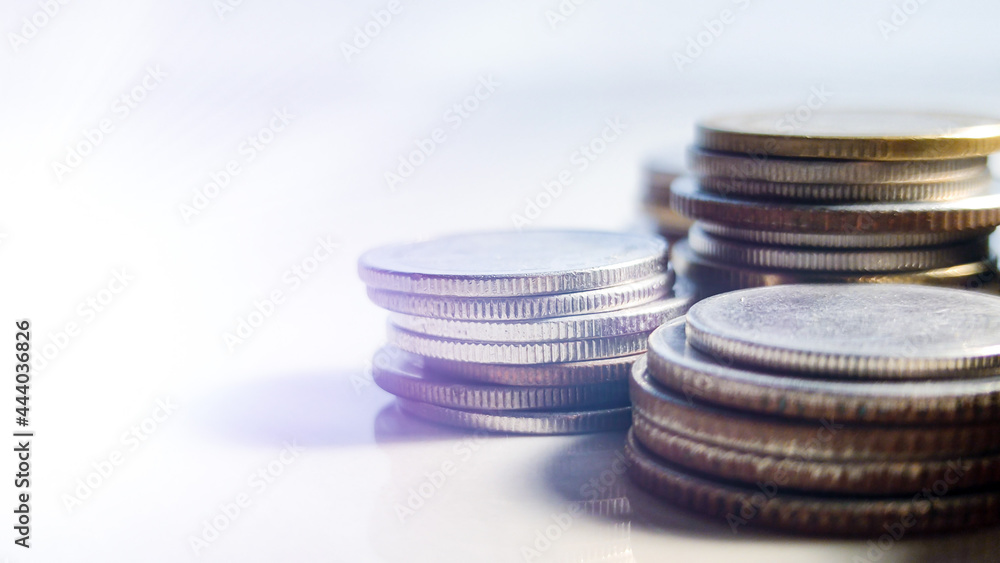 Double exposure of light and stack of coins for finance and banking concept, coins stacked background, copy space for texting. Double exposure of light and stack of coins for finance and banking concept, coins stacked background, copy space for texting.