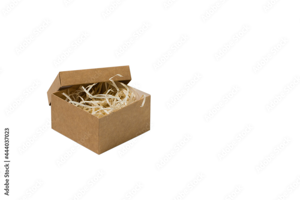 Square craft box with wood filler, isolated on white background. The concept of choosing a gift and preparing for the holiday Square craft box with wood filler, isolated on white background. The concept of choosing a gift and preparing for the holiday