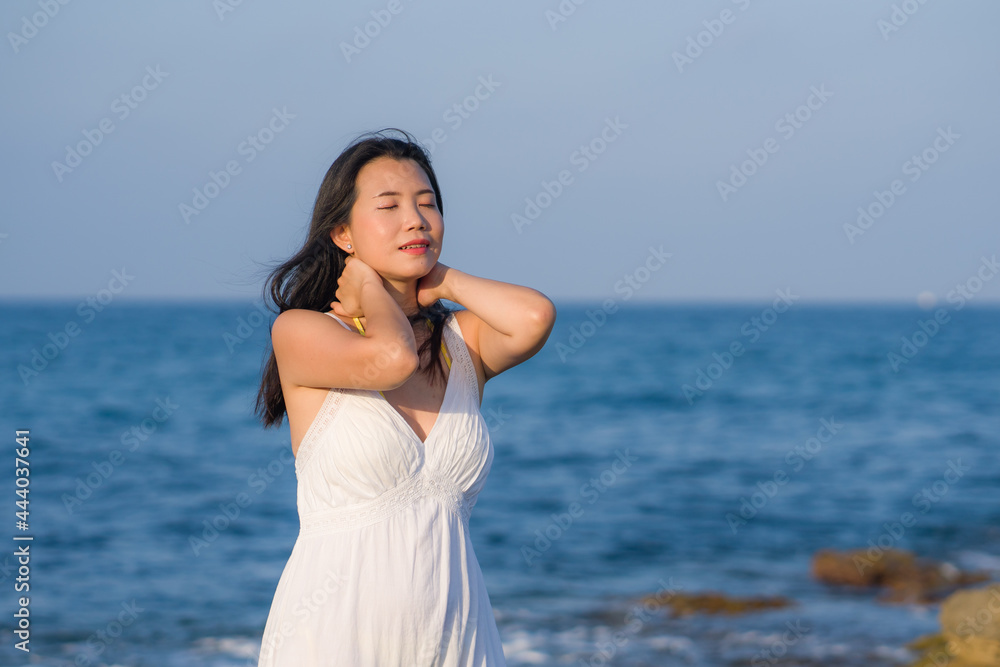 summer lifestyle portrait of young beautiful and happy Asian woman at the beach - Attractive Korean girl by the sea enjoying holidays trip on rock cliff with ocean view summer lifestyle portrait of young beautiful and happy Asian woman at the beach - Attractive Korean girl by the sea enjoying holidays trip on rock cliff with ocean view