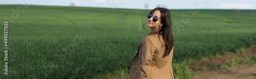 Portrait of a positive cheerful brunette girl in a green spring park.