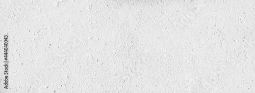 Surface texture of white concrete wall, cement pattern with cracks background with space to copy, panoramic view