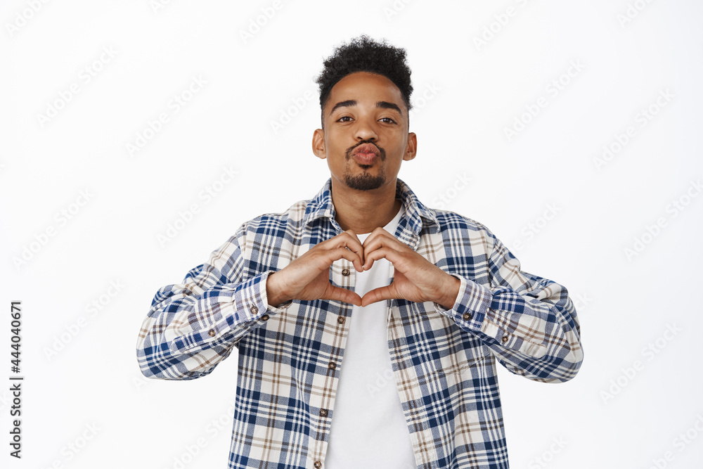 Lovely Black man kissing, boyfriend showing heart I love you gesture, hipster guy confess in sympathy, like someone, standing over white background Lovely Black man kissing, boyfriend showing heart I love you gesture, hipster guy confess in sympathy, like someone, standing over white background