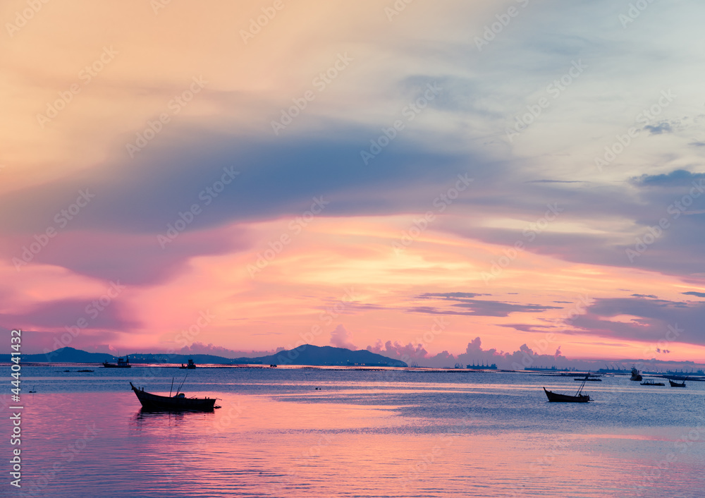 sunset over the sea and small fishing boats sunset over the sea and small fishing boats