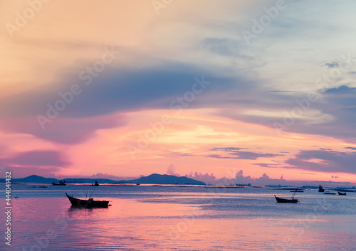 sunset over the sea and small fishing boats