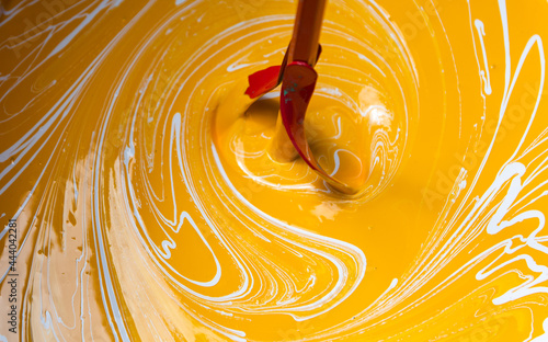 Photography Mixing different color paint together for painting walls