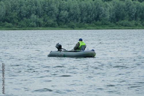 Fishing on the river. Fishermen fish from a rubber boat on the river. summer in good weather.