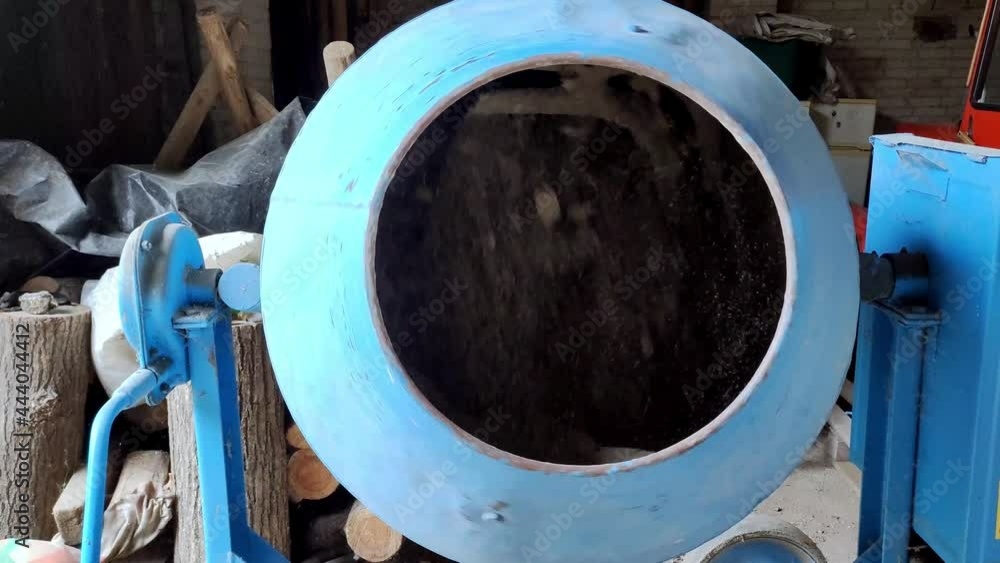 Concrete mixing close up. Concrete being poured out of the concrete mixer.
Concrete mixing close up. Concrete being poured out of the concrete mixer.