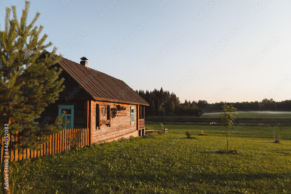 wooden european house in a picturesque countryside at sunset in summer wooden european house in a picturesque countryside at sunset in summer