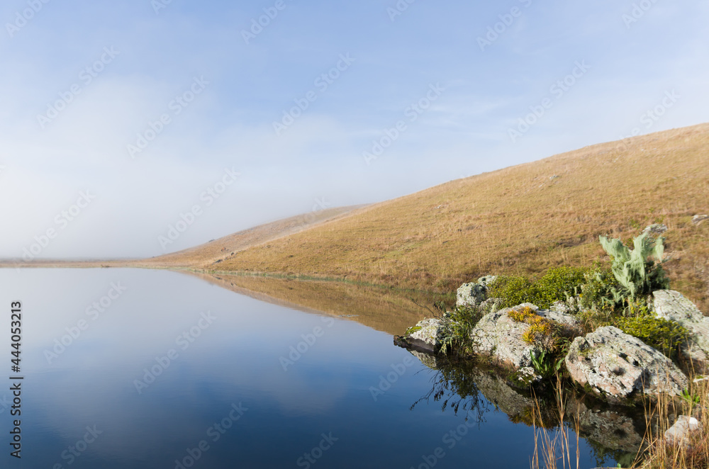Beautiful lake landscape in a foggy day