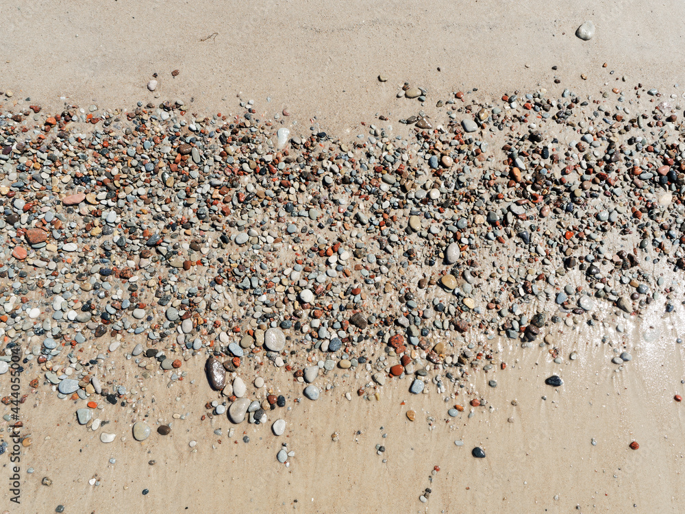 Seashore and small colored pebbles.