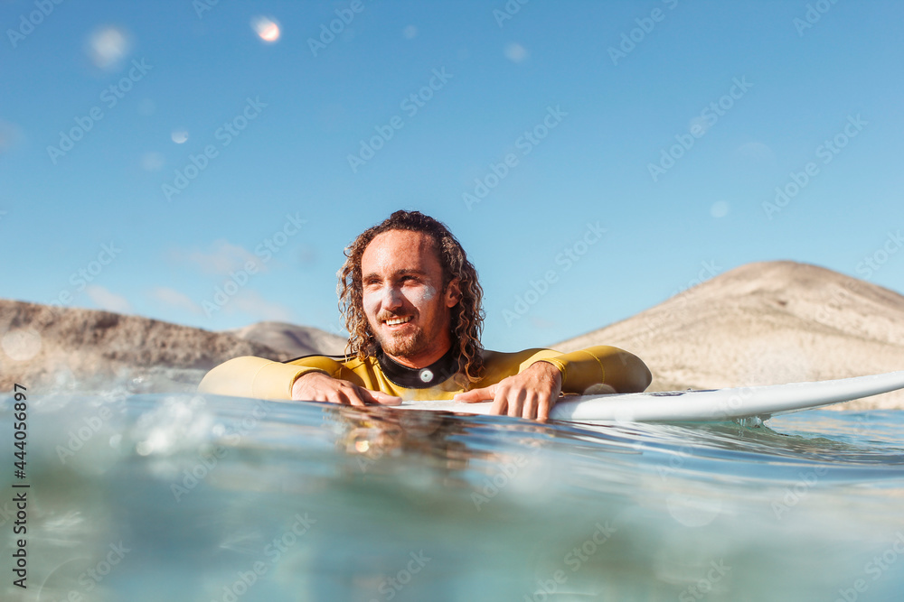 Handsome man surfing in the sea