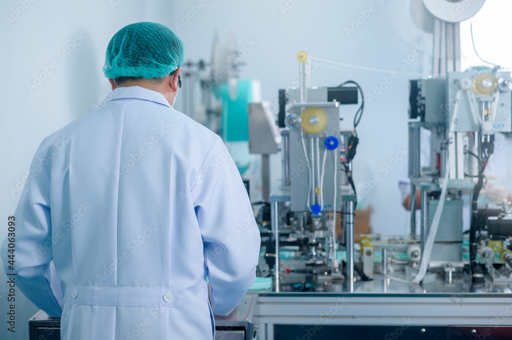 Workers producing surgical mask in modern factory, Covid-19 protection and medical concept. Workers producing surgical mask in modern factory, Covid-19 protection and medical concept.