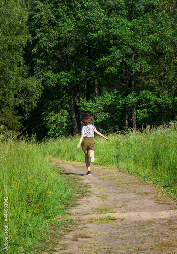 Fototapeta Naklejka Na Ścianę i Meble -  person running in the forest in semmer