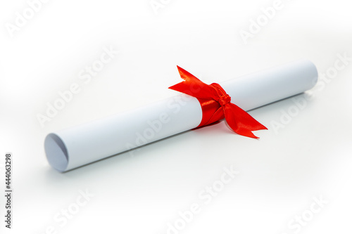 Photography Solemn diploma of the graduate about the completion of studies with a red ribbon on a white background
