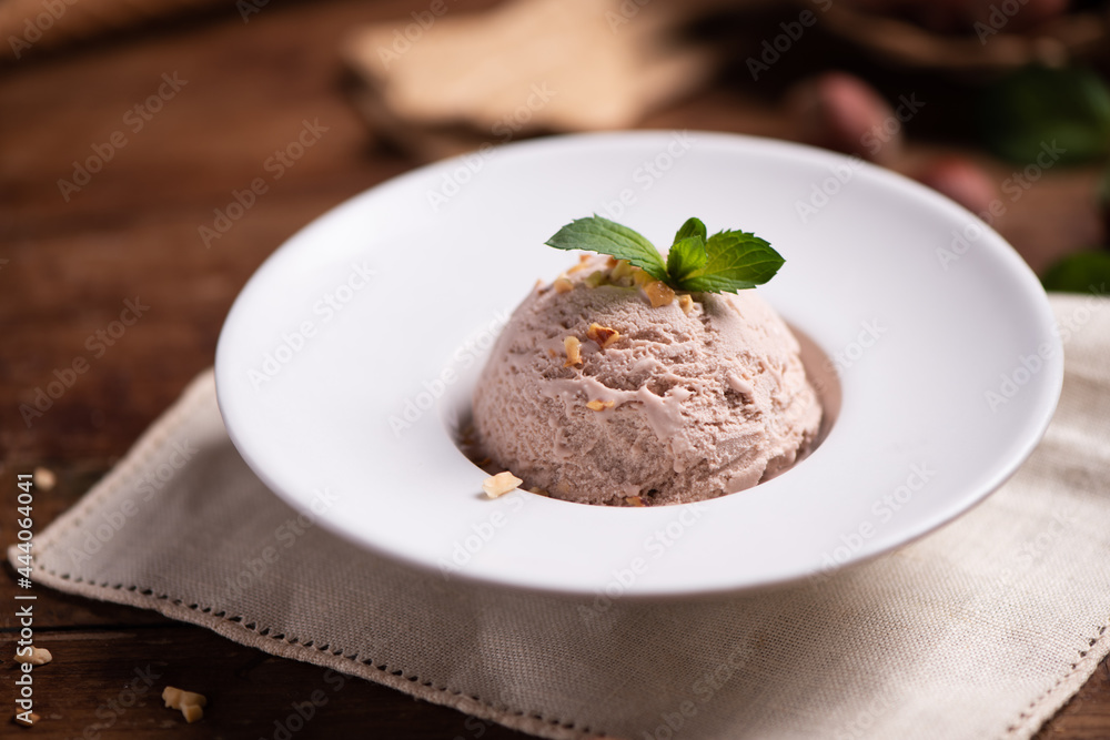 Fresh hazelnut ice cream on wooden table Fresh hazelnut ice cream on wooden table