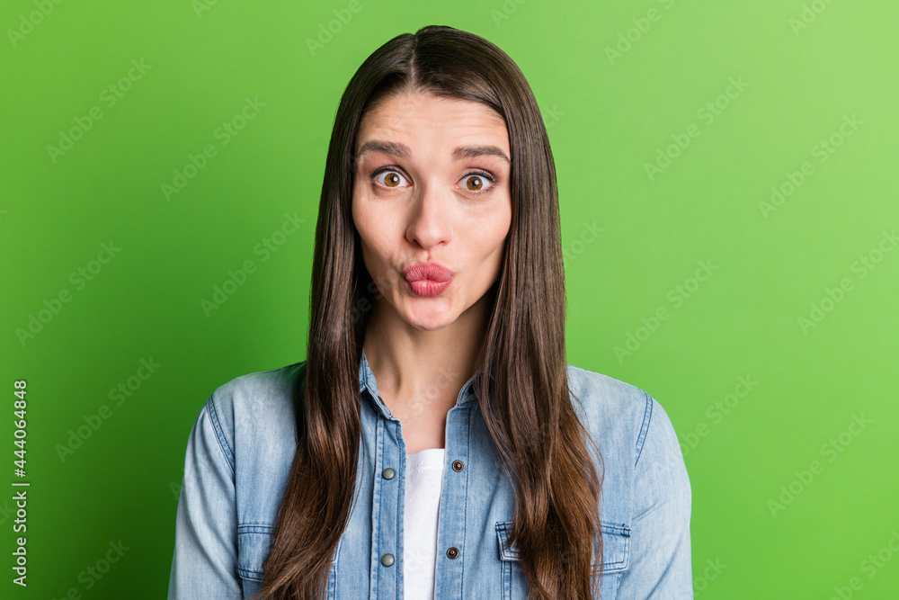 Portrait of attractive funny cheerful girl fooling pout lips isolated over bright green color background Portrait of attractive funny cheerful girl fooling pout lips isolated over bright green color background