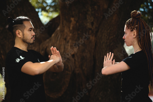 couple practicing kung fu in the park