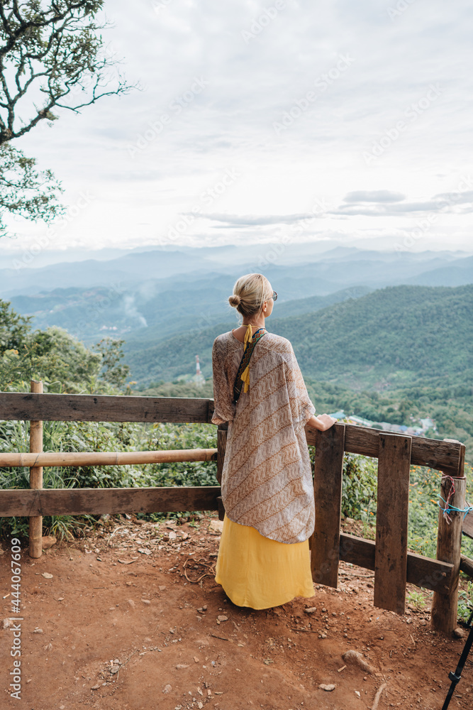 Yong woman watching Sunset in the Mountains at Doi Pui Viewpoint Doi Suthep-Pui National Park